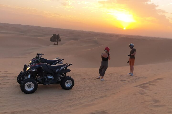 Experience an unforgettable sunset as you explore the desert on a quad bike followed by a private BBQ dinner under the expansive sky perfect for adventure and relaxation.